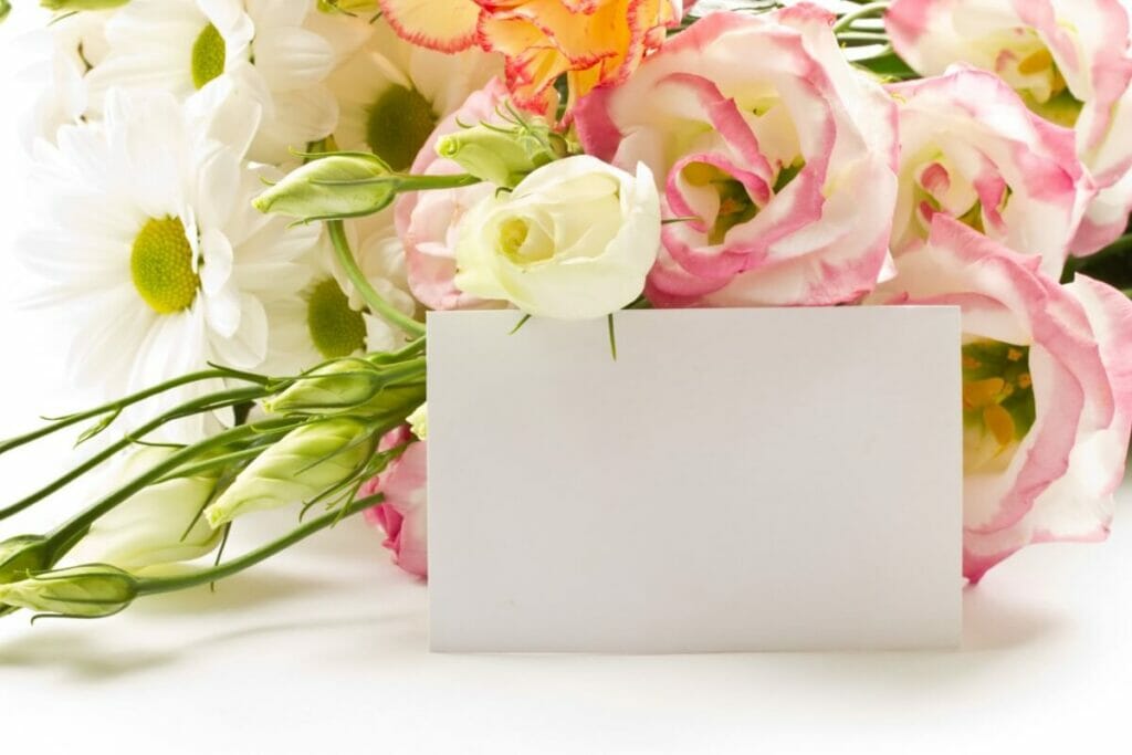 A bouquet of flowers with a blank card