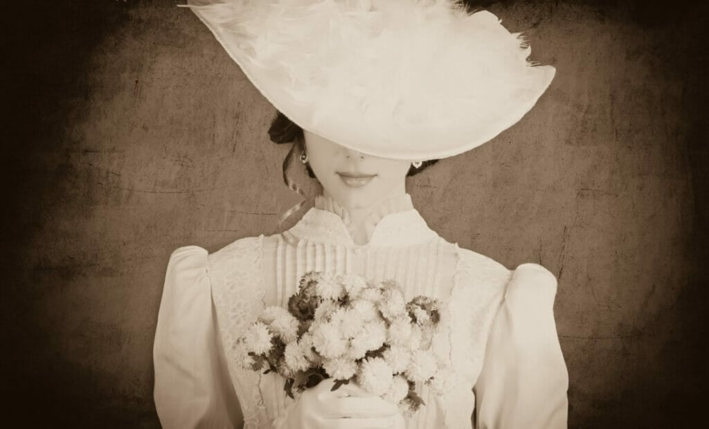 A black and white photo in the style of Victorian times with a lady holding a bouquet of flowers