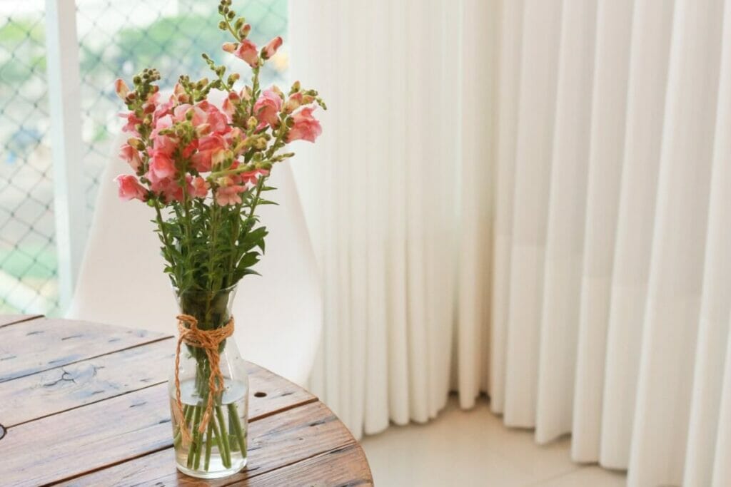 Vase with a bunch of pink snapdragon flowers
