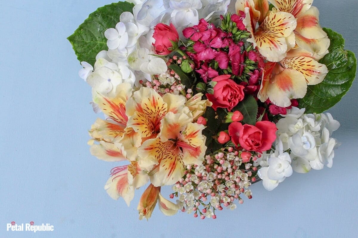 A beautiful vase arrangement filled with fresh cut seasonal flowers