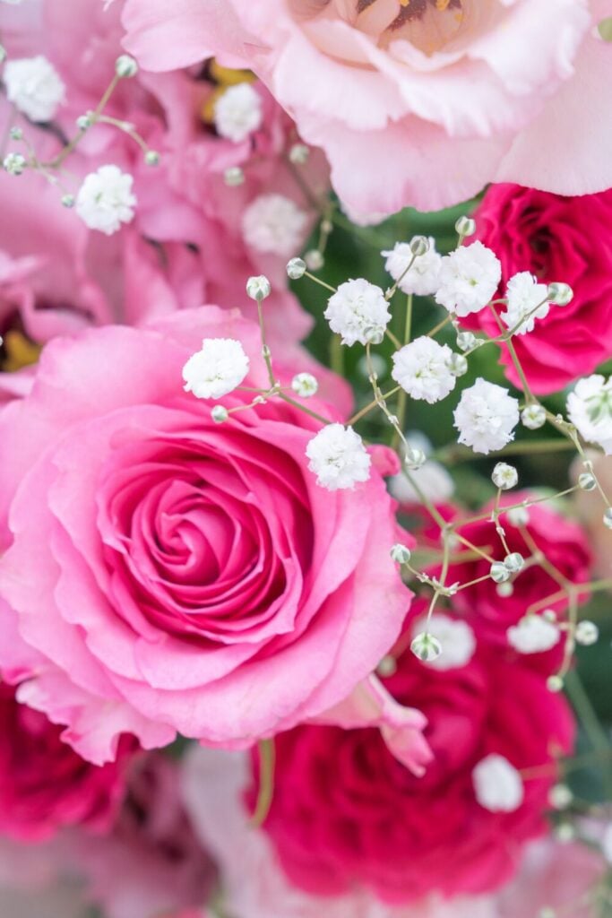 Vibrant bouquet of bright pink roses, soft lisianthus, and white Baby’s Breath for a bold yet romantic wedding look.