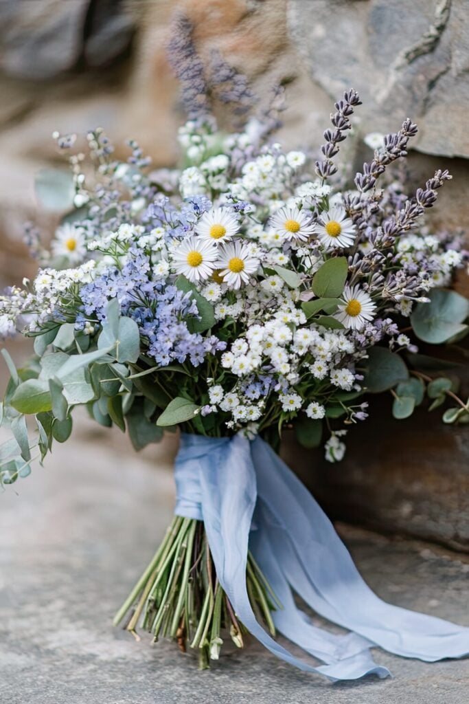 Boho wedding bouquet with pampas grass, Baby’s Breath, ivory roses, and a soft blue ribbon.
