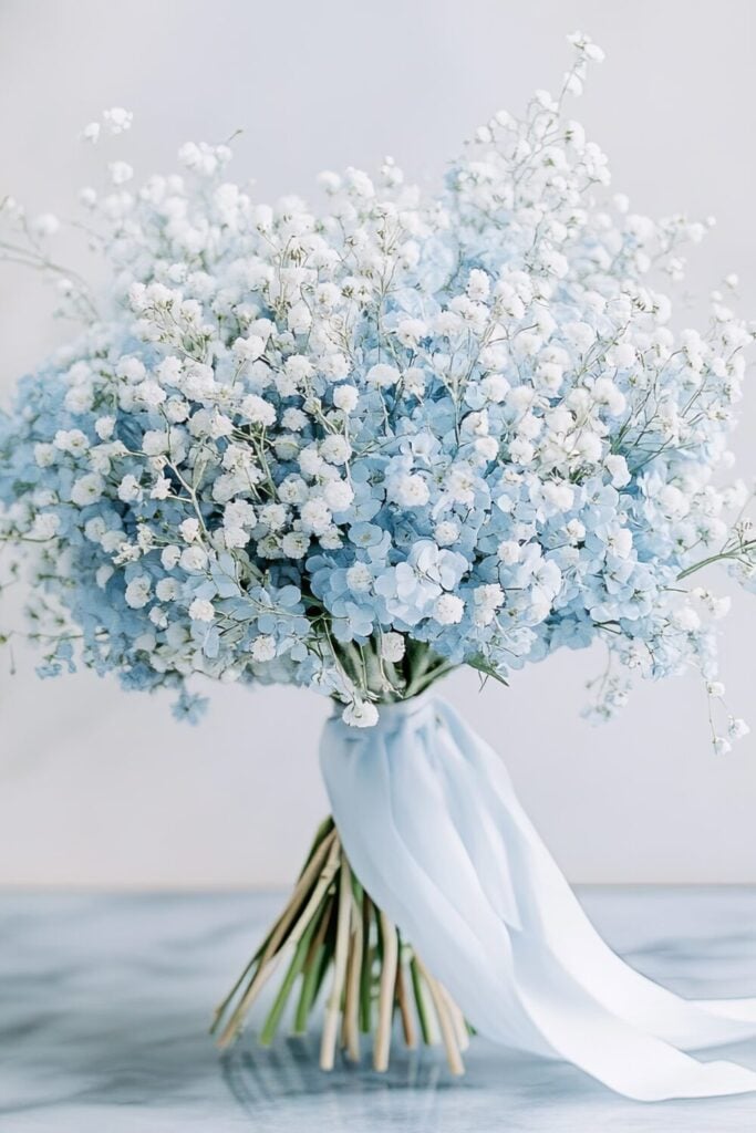 Wedding bouquet featuring blue and white Baby’s Breath with a flowing blue ribbon.