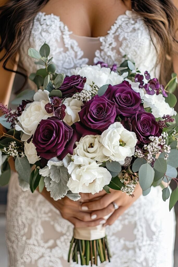 Elegant wedding bouquet with plum roses, white blooms, and lush greenery for a timeless look.