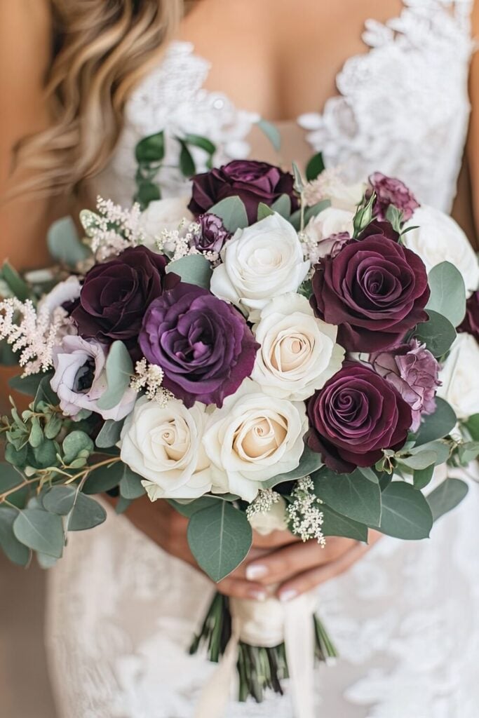 Vintage-inspired wedding bouquet with plum and blush roses, daisies, and delicate greenery.